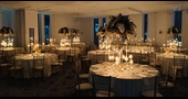 An interior of a wedding venue with candles on dining tables