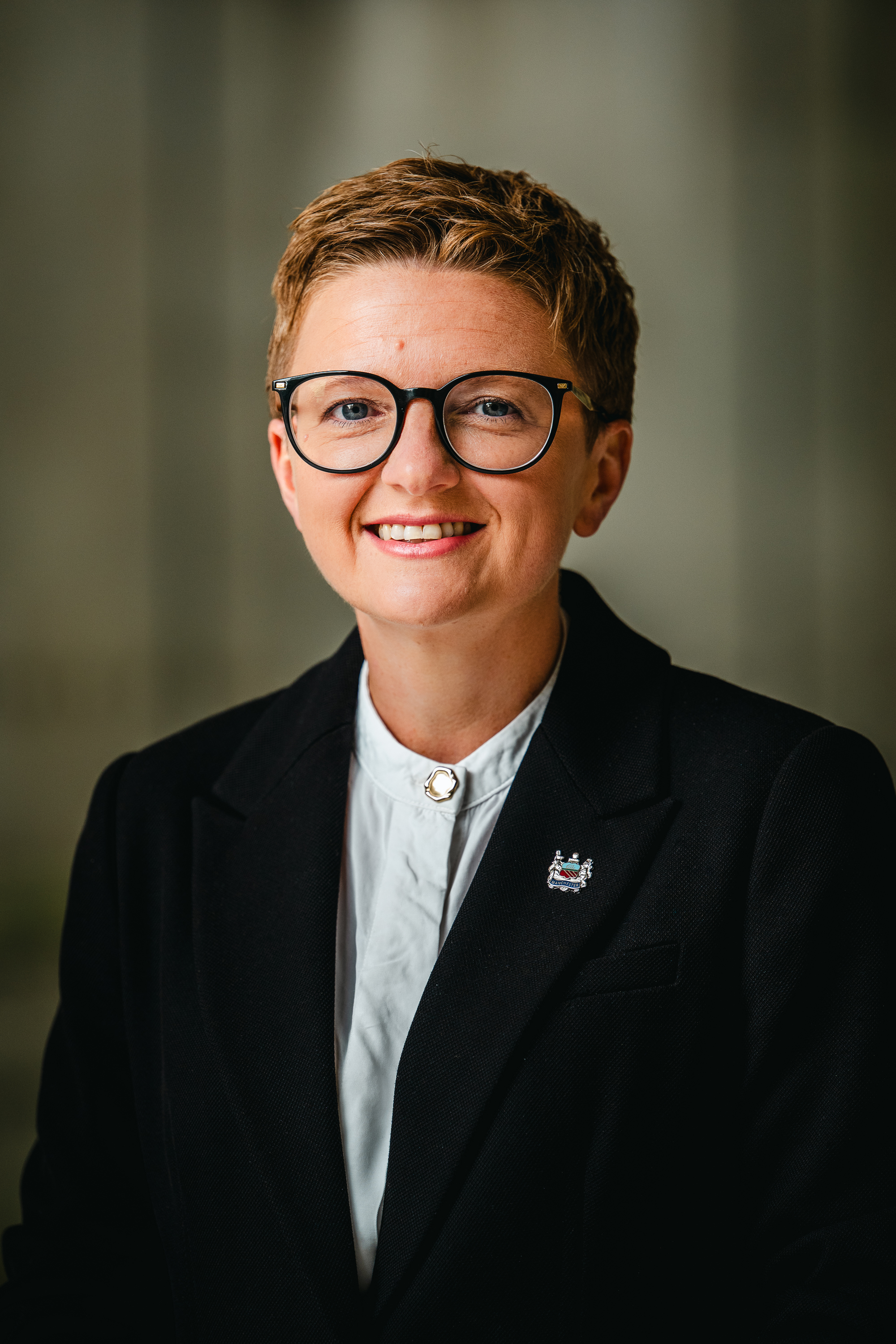 Councillor Bev Craig looking at the camera smiling, wearing a black jacket and white shirt