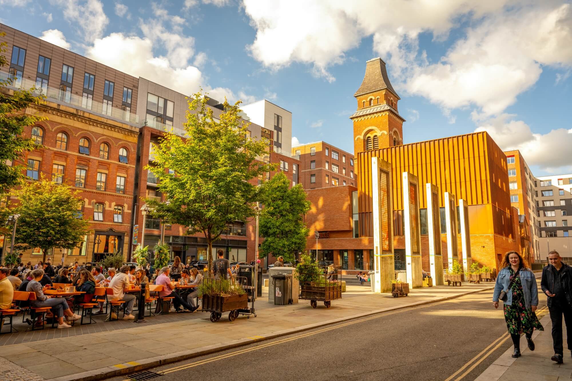 Cutting Room Square in Ancoats with outdoor seating and eating and a mix of historic buildings and new development. 