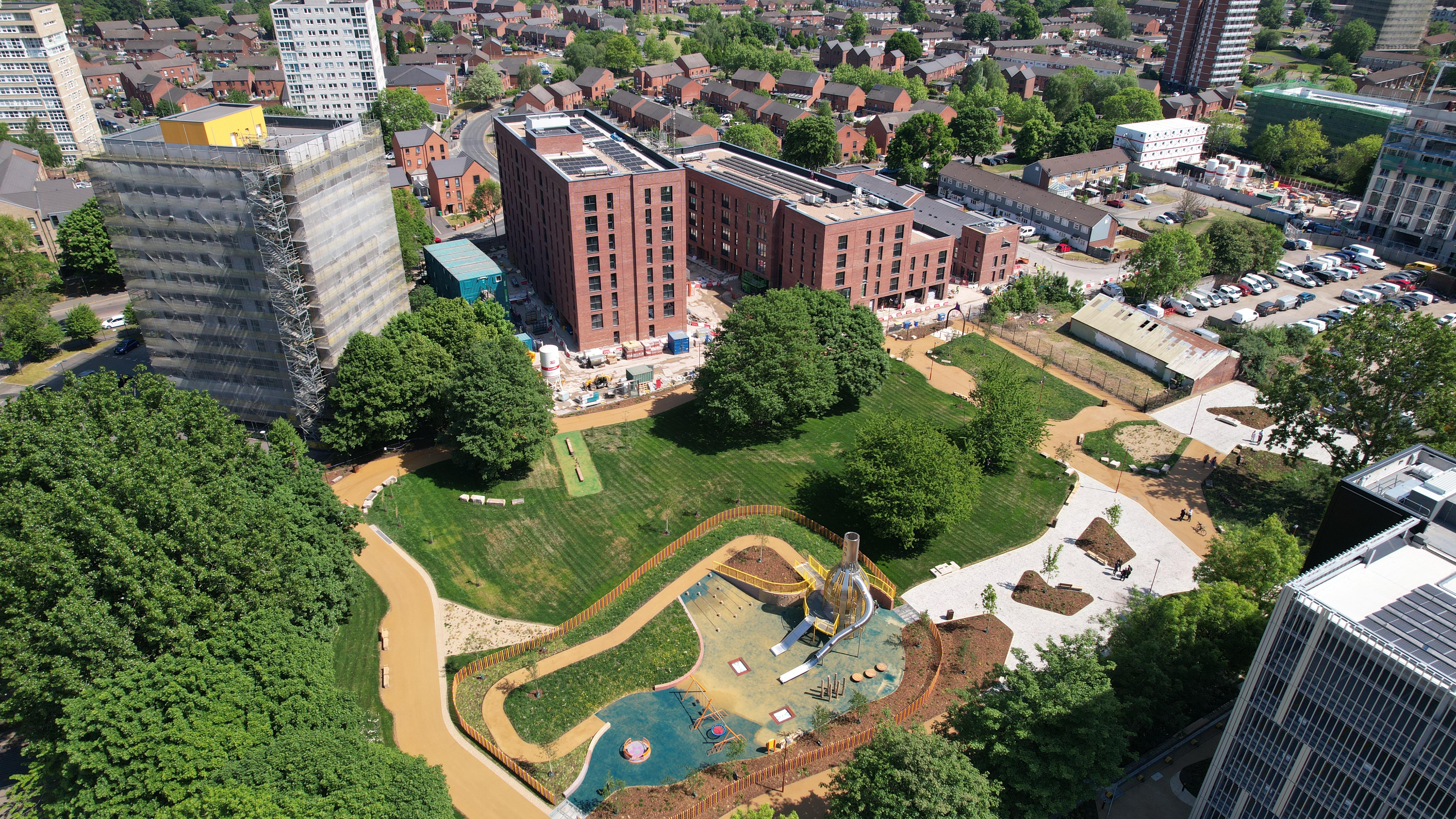 drone image at height over the first This City development in Ancoats next to the refurbished green