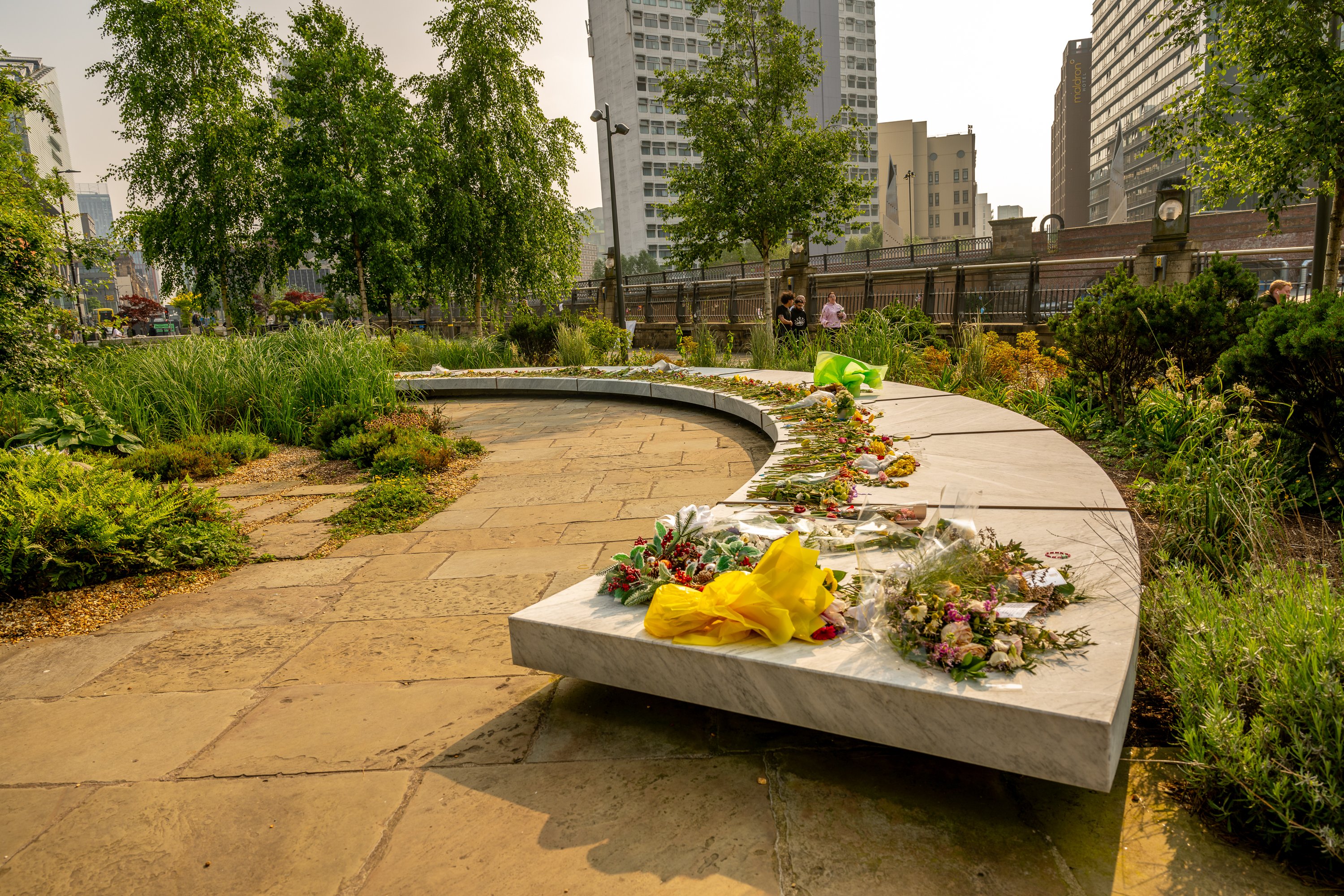 A photo of the Glade of Light memorial. There a flowers placed on it in memory of the victims of the attack.