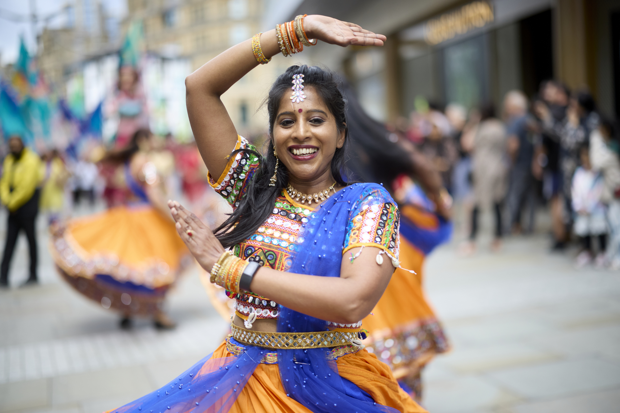 Woman in traditional dress dancing in the street