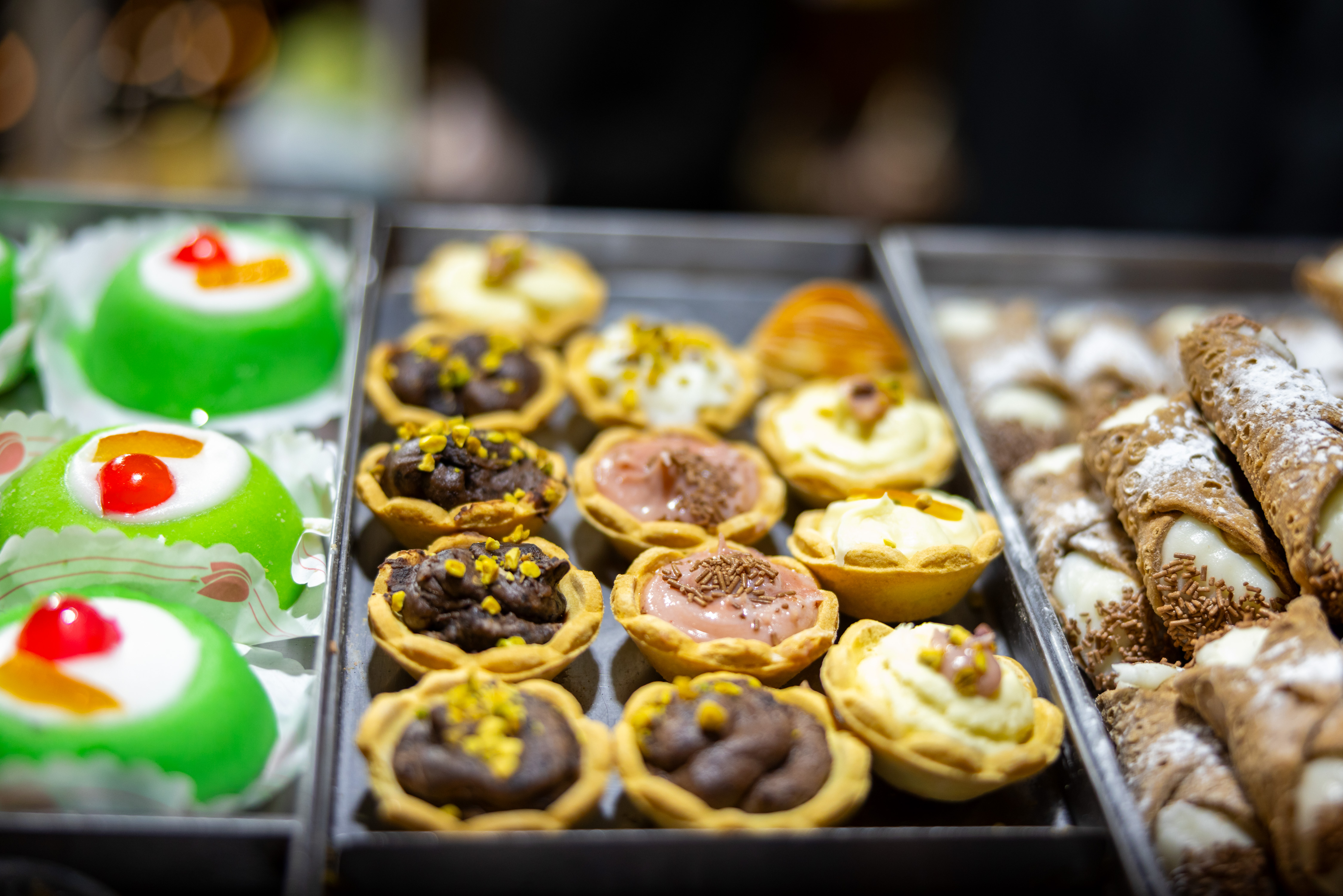 Close-up shot showing trays of brightly decorated small cakes