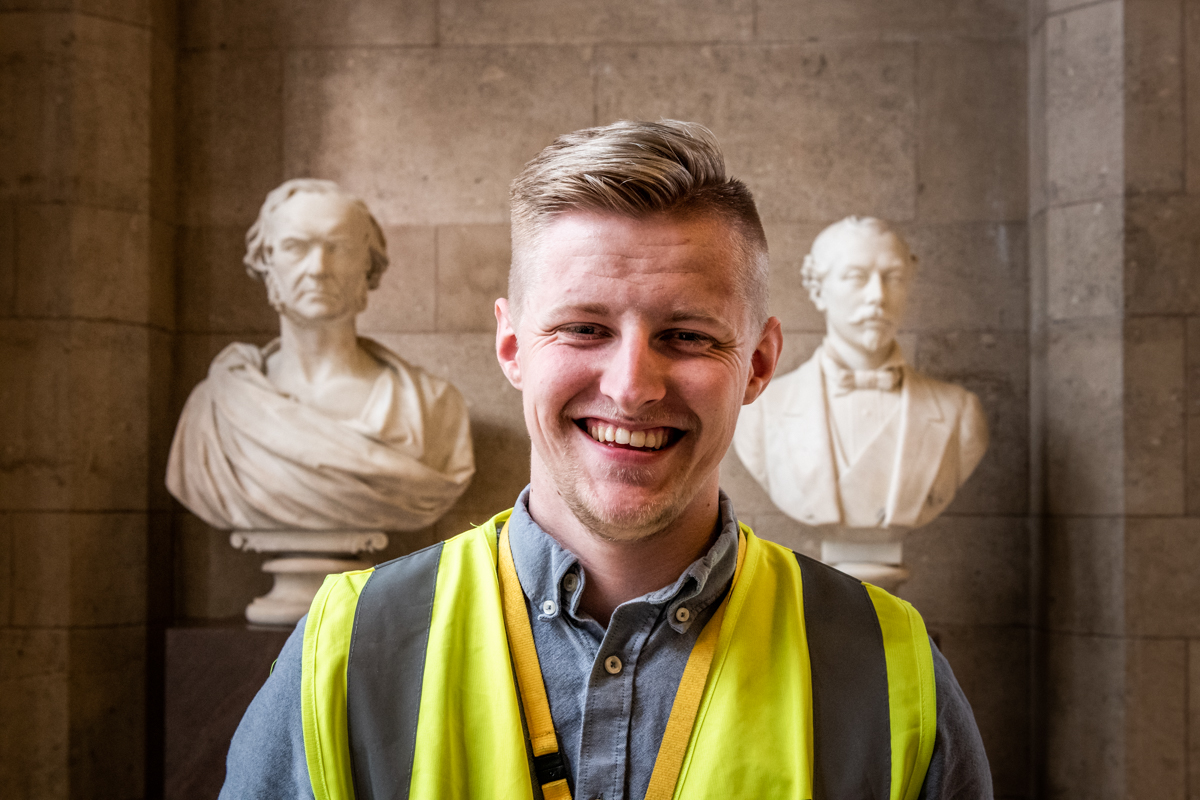 Image shows Dylan Pritchard with two of the Town Hall sculptures. The image was taken during his apprenticeship.
