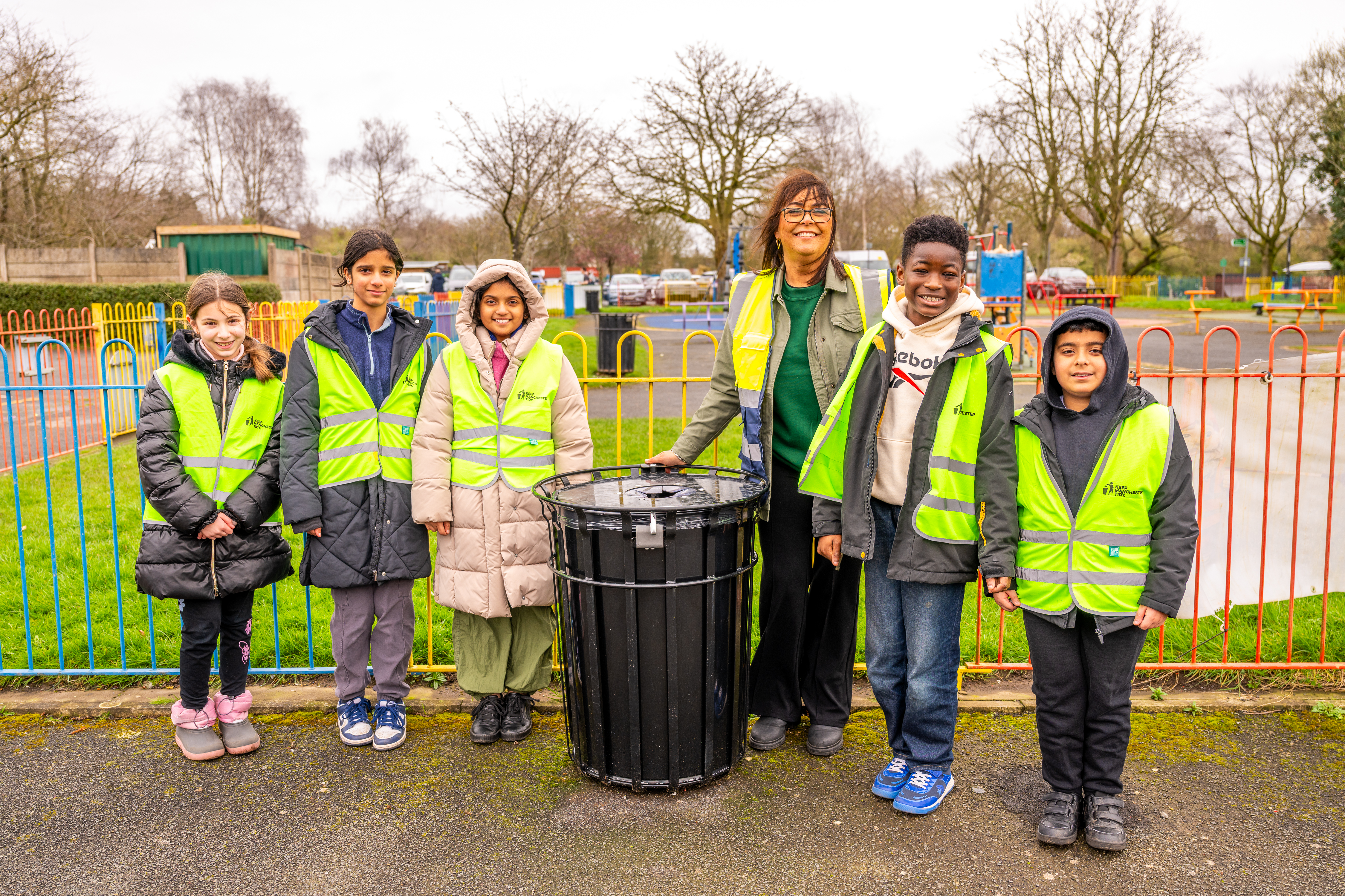 Lee Ann Igbon pic around a new bin with school children
