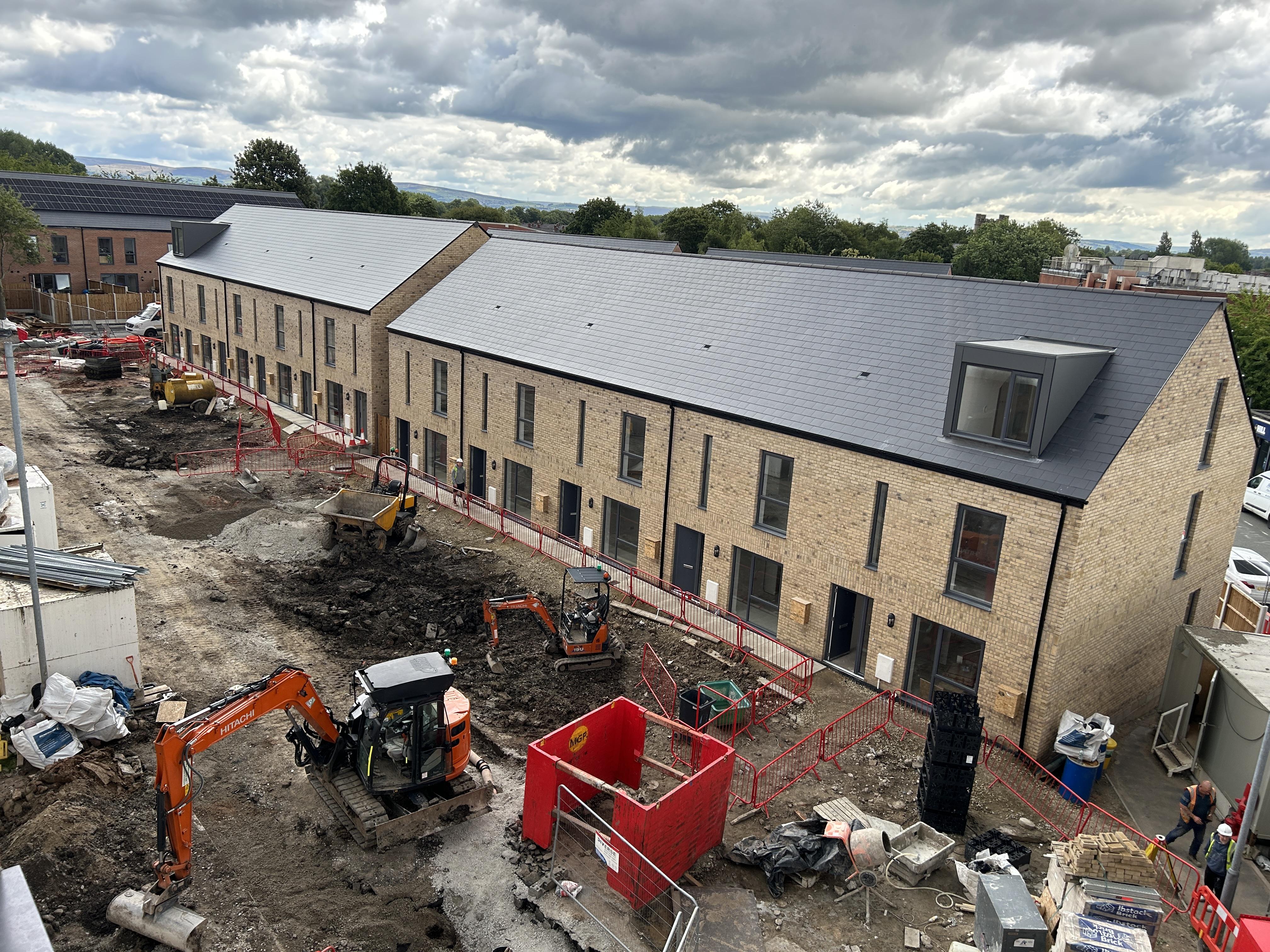 an elevated view looking down at a row of new houses at Silk Street in Newton Heath