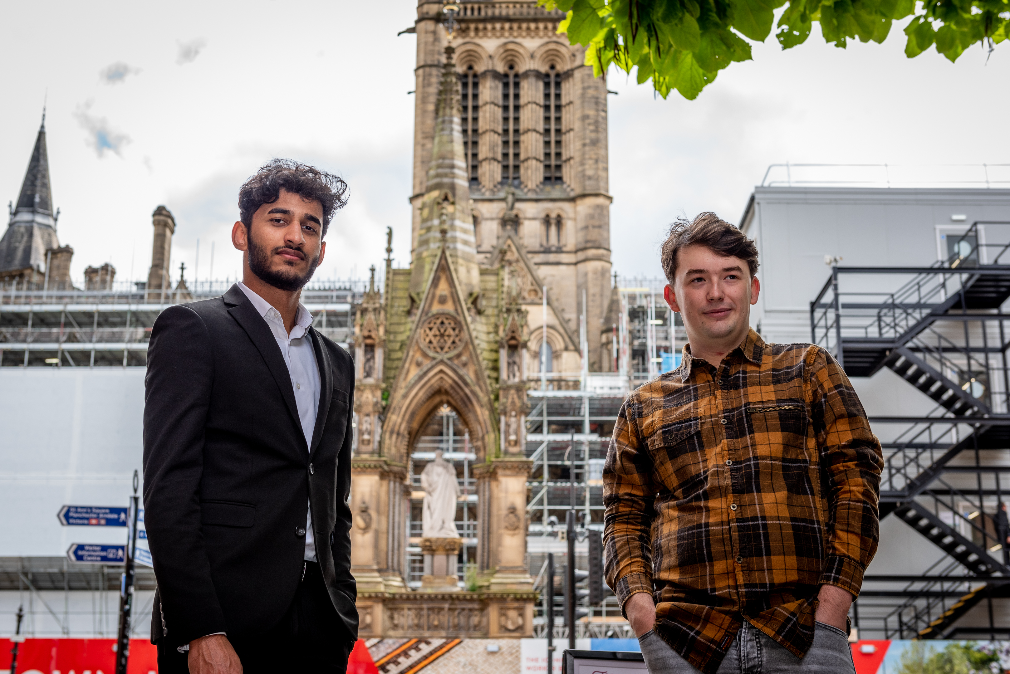 Image shows Abdul and Matt in front of the Town Hall in Manchester 