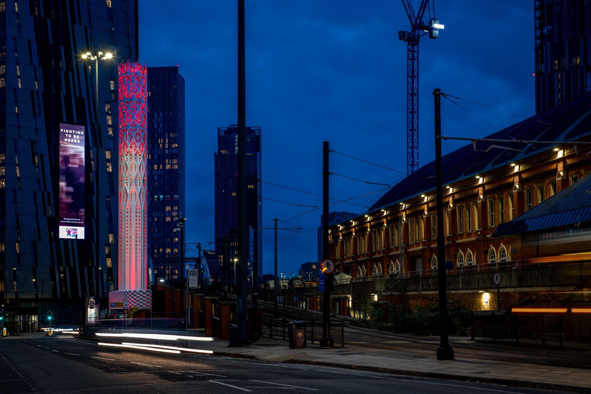 The sculptural Tower of Light illuminated at night 