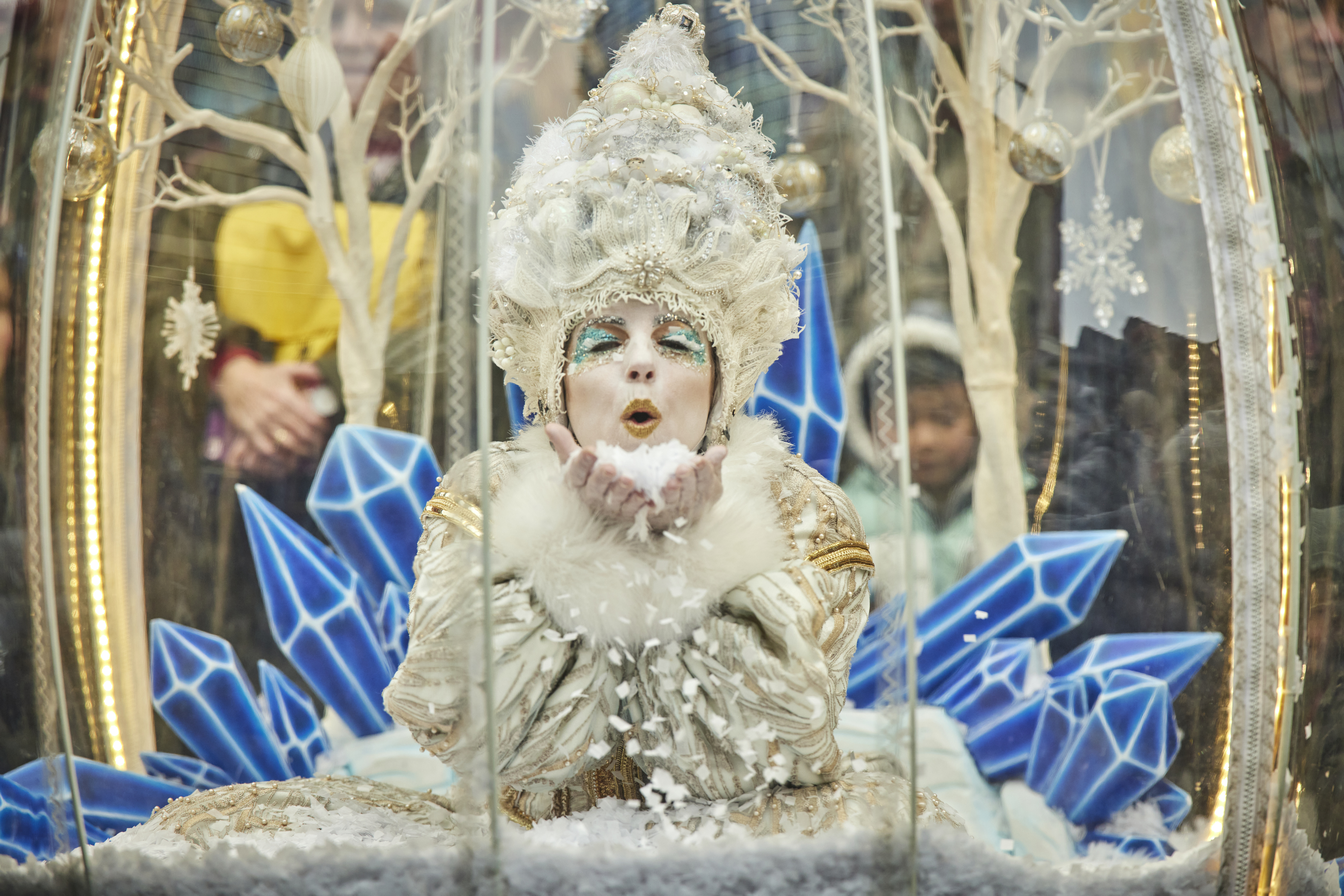 Bejewelled Snow Queen leans forward blowing a kiss to the camera
