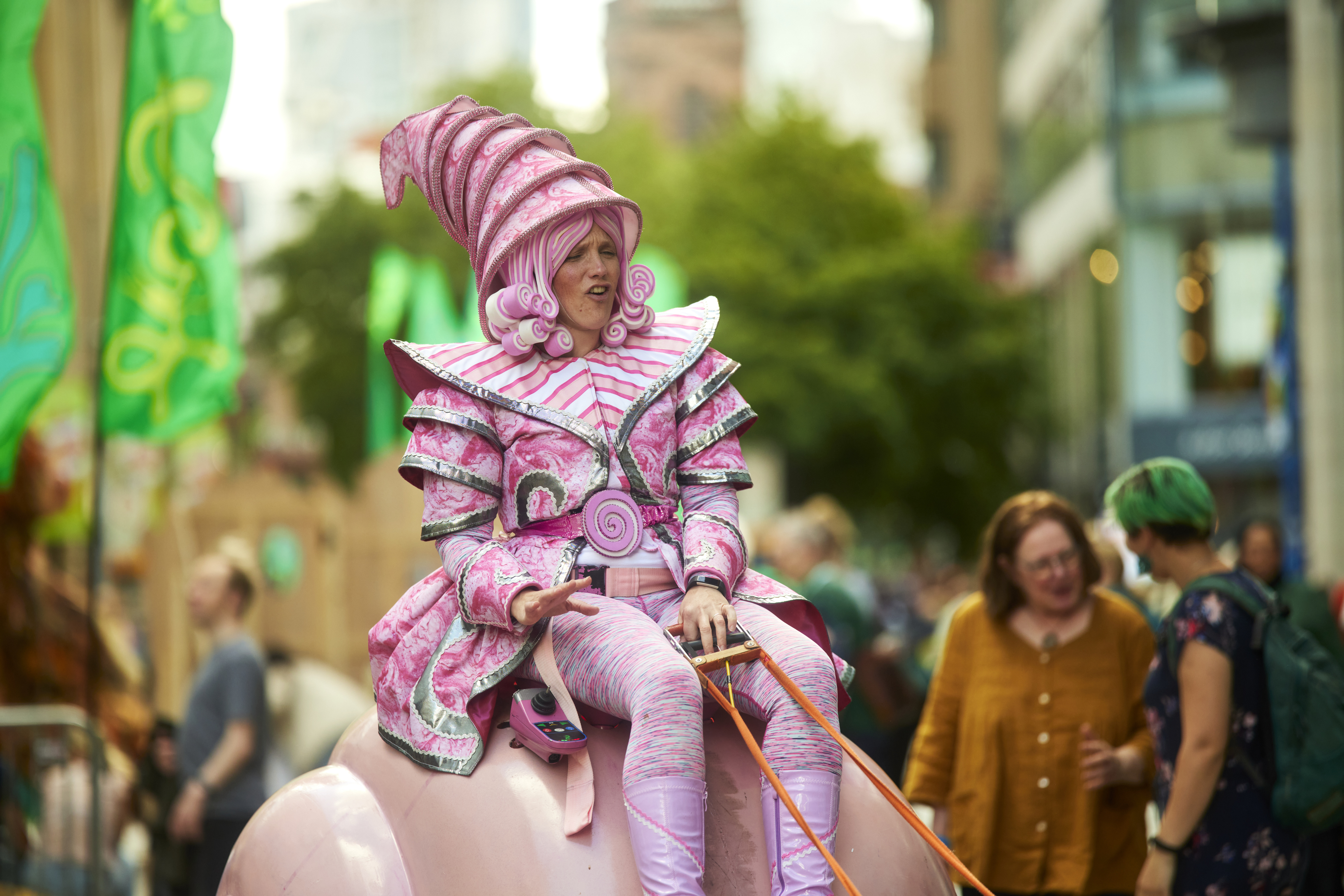 A performer rides a giant snail at Manchester Day event