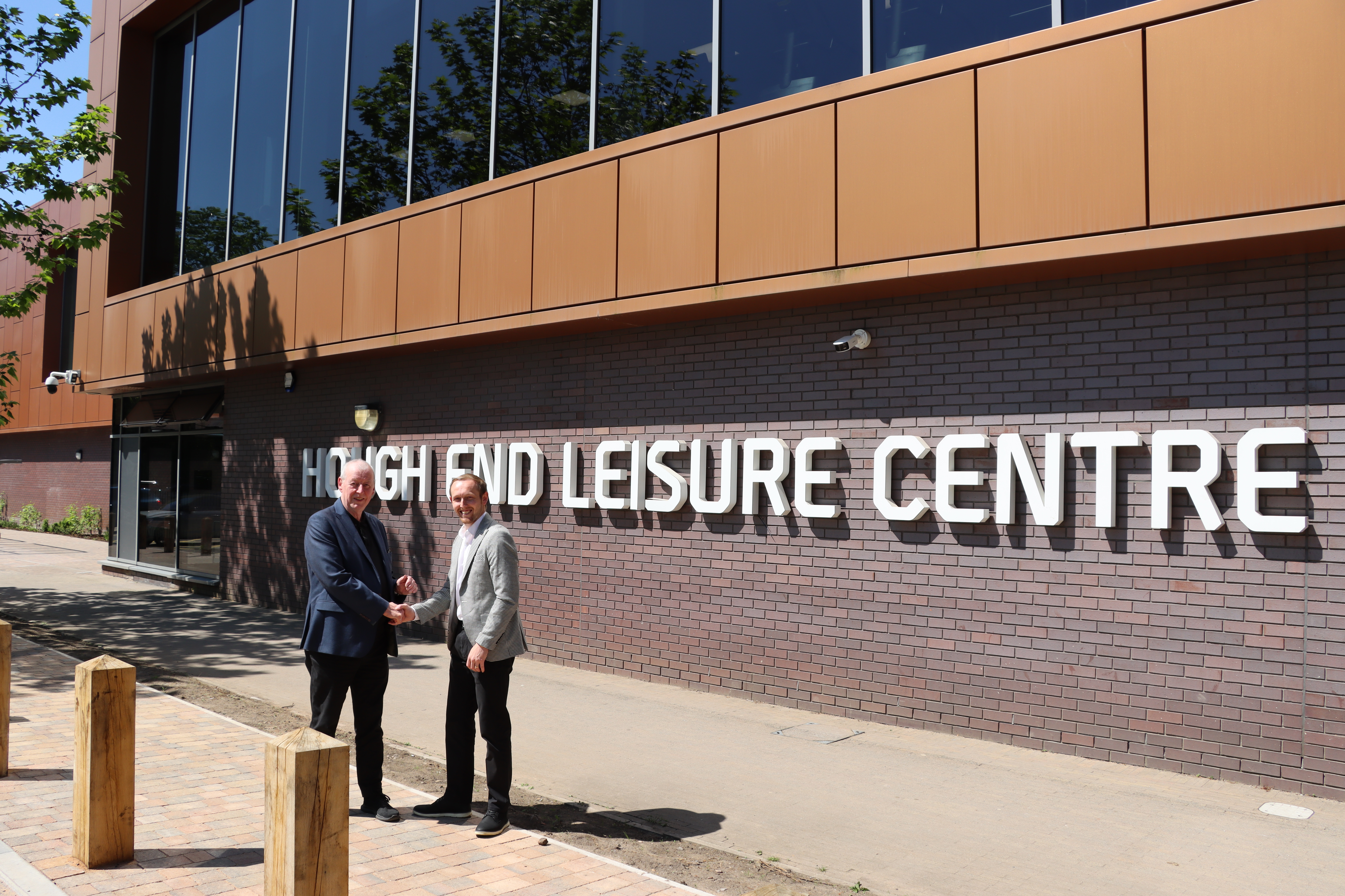 Officials stand outside Hough End Leisure centre for its re-opening