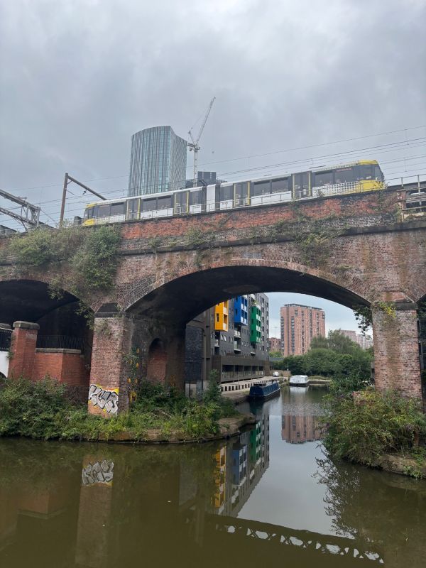 A photo of a tram on a bridge over the water