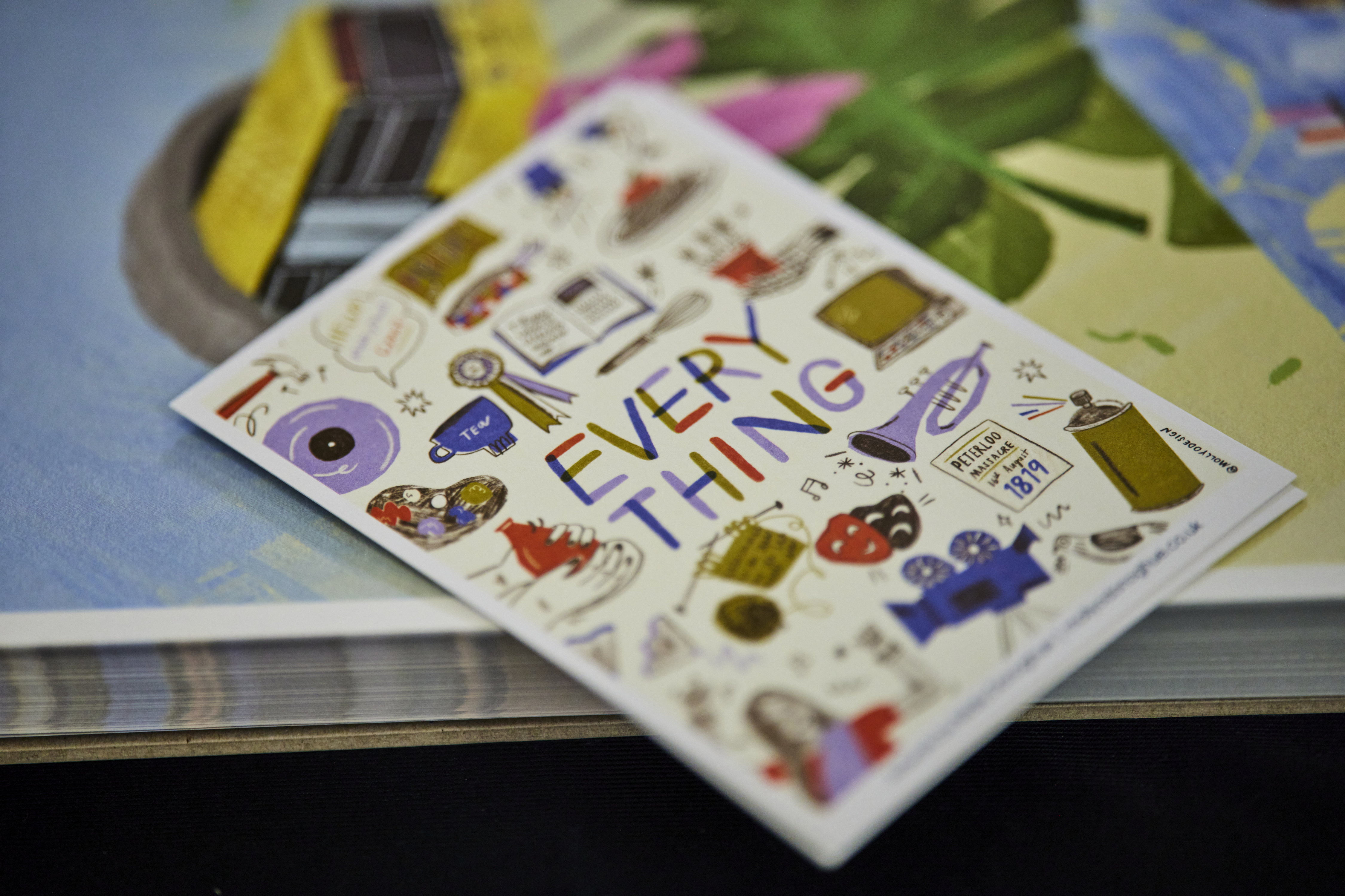 Brightly coloured leaflet with the word Everything written on it, lying on a table