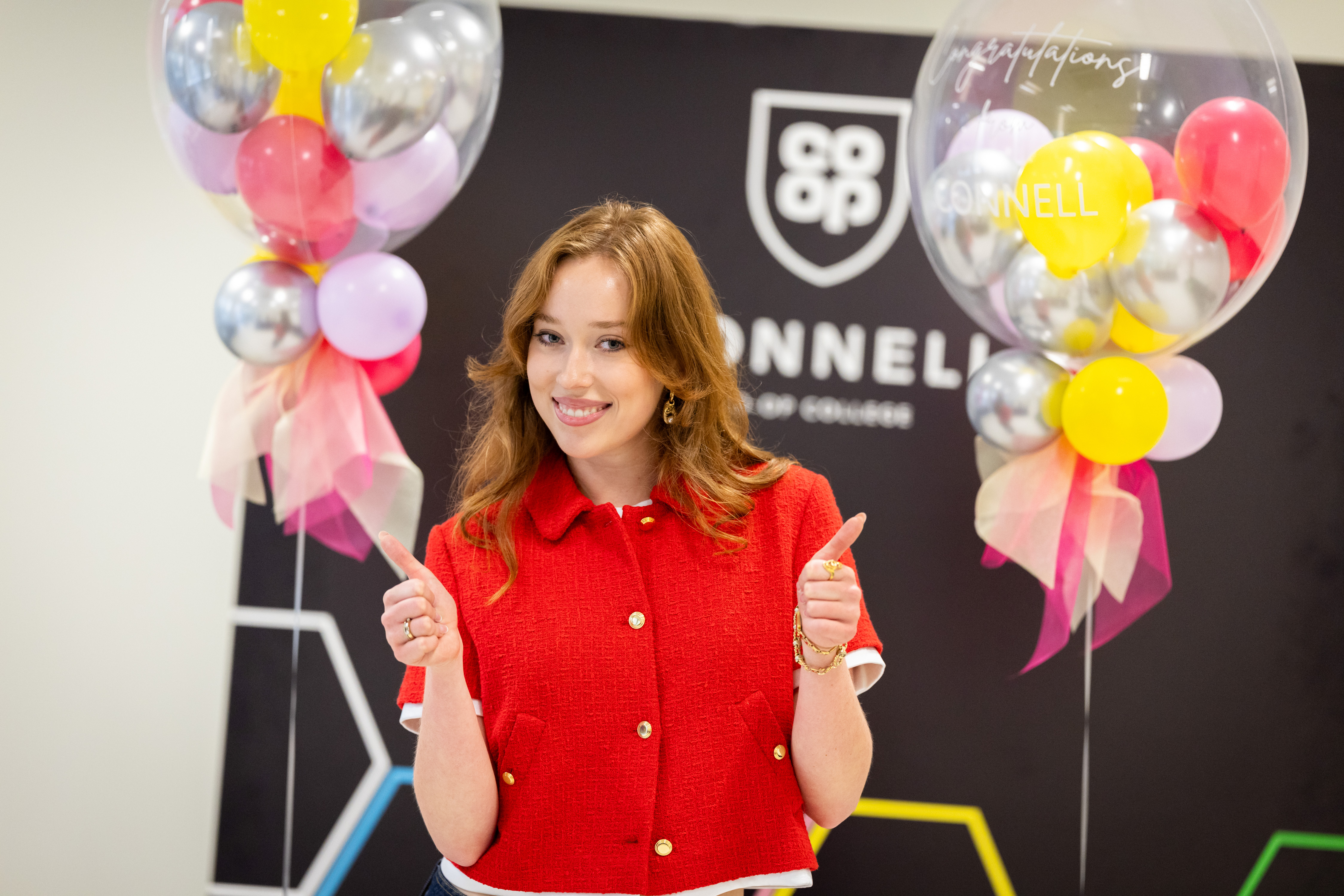 Teenage girl looking at camera smiling as she holds both hands up giving a thumbs up sign Teenage girl looking at camera smiling as she holds both hands up giving a thumbs up sign