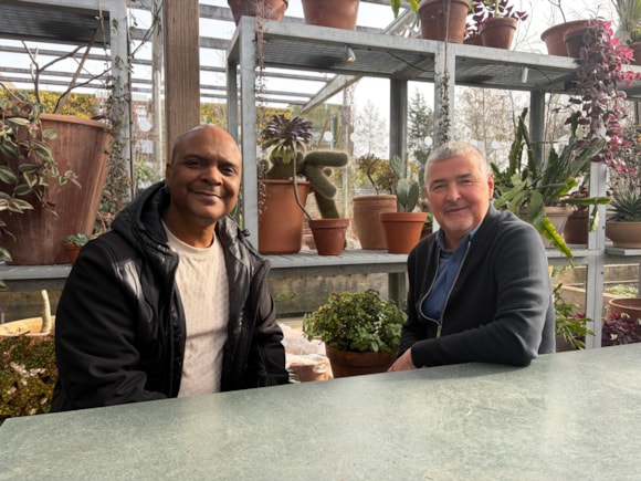 Two men sitting next to eachother.