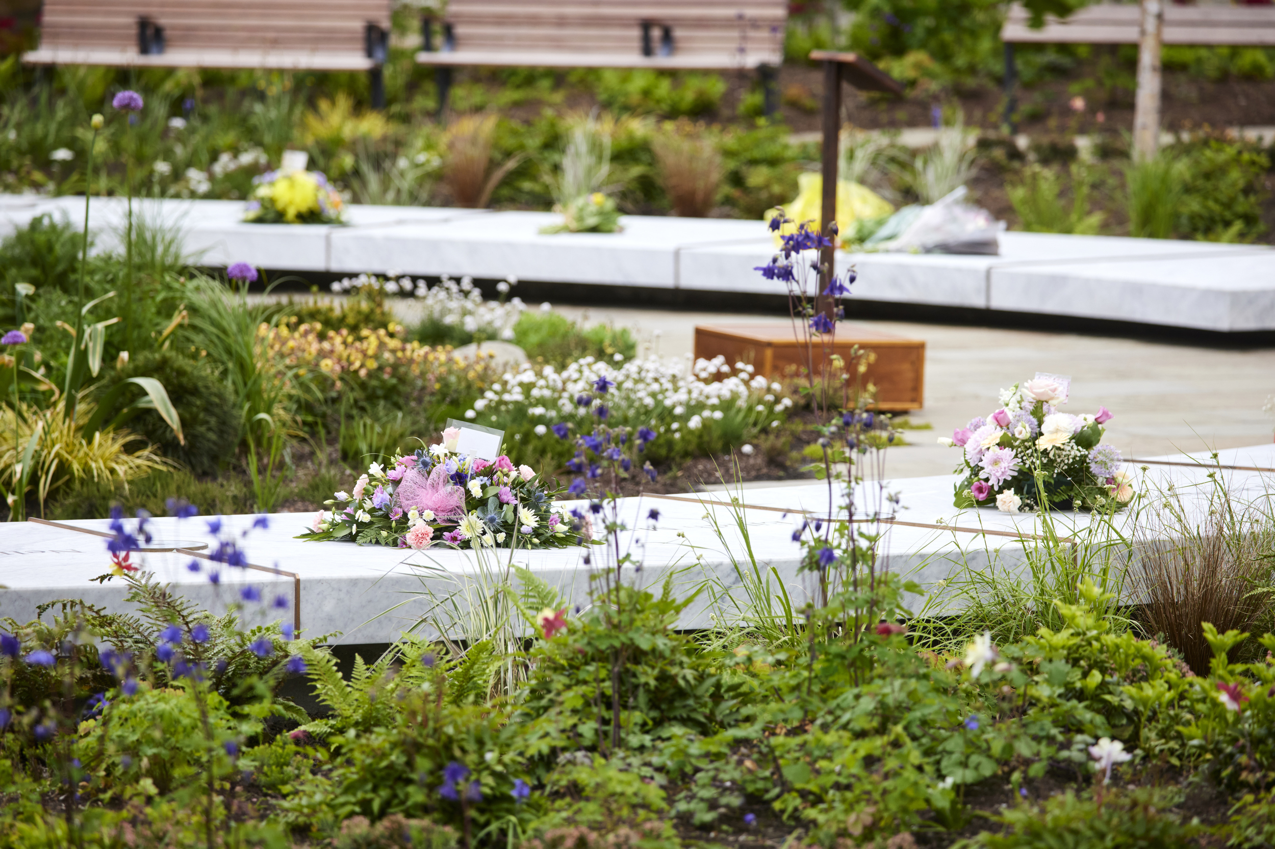 Image of the Glade of Light memorial with floral tributes